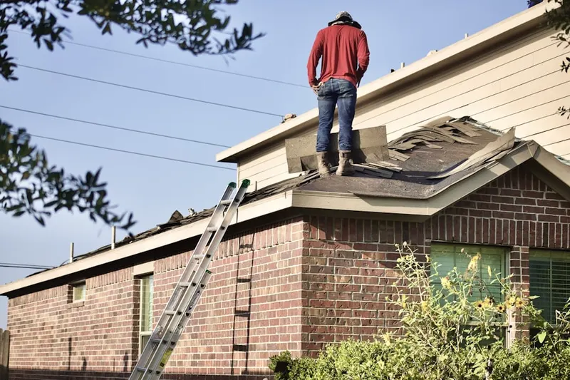 Professional roofer working on a residential roof in New Britain